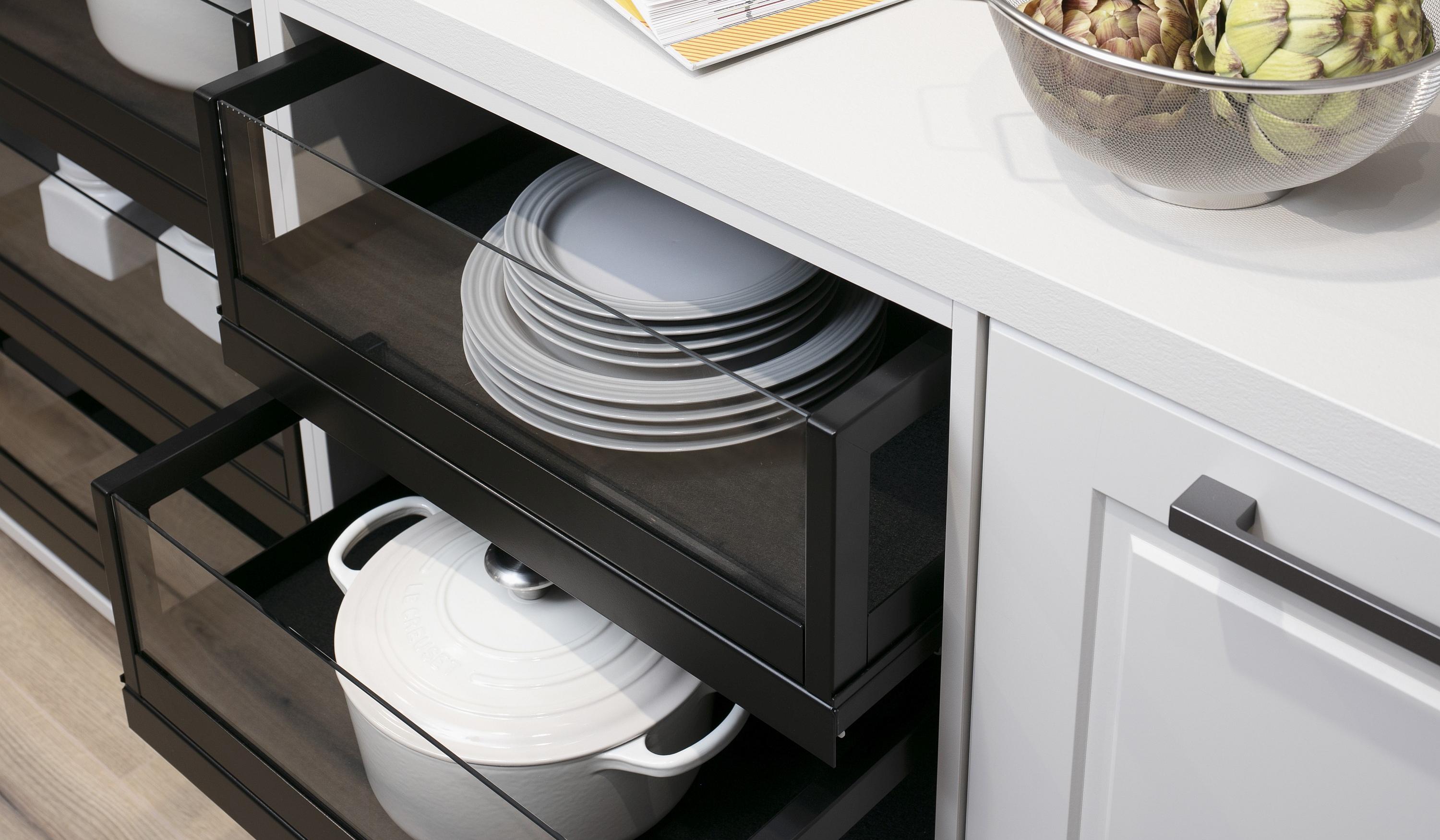 Grauglas-Auszüge mit Metallrahmen in einer weißen Landhausküche